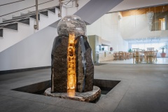 Our foyer with illuminated onyx reception desk and wooden ceiling